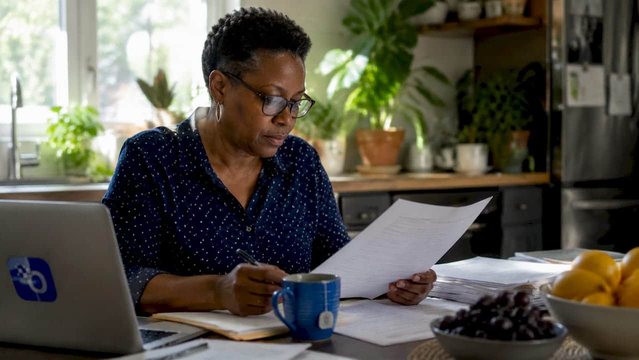 Woman reviewing data governance documents in office