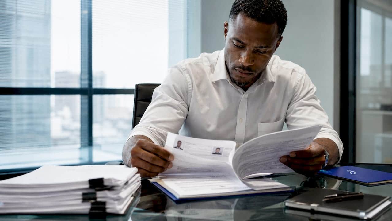 Man reviewing background check documents