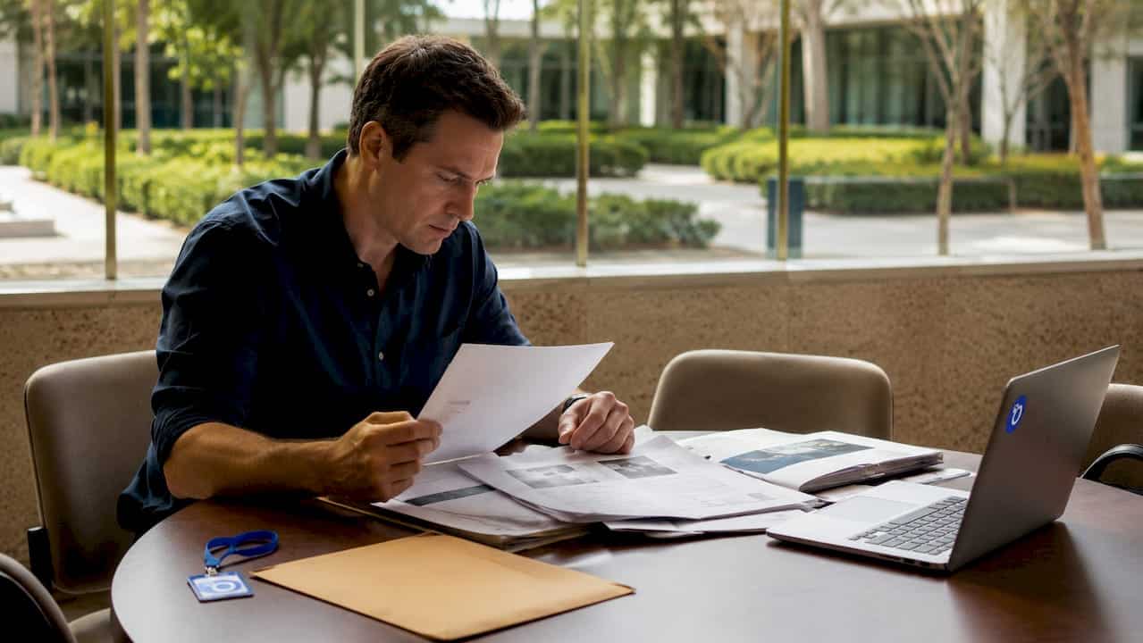 Investigator reviewing post-hire monitoring files