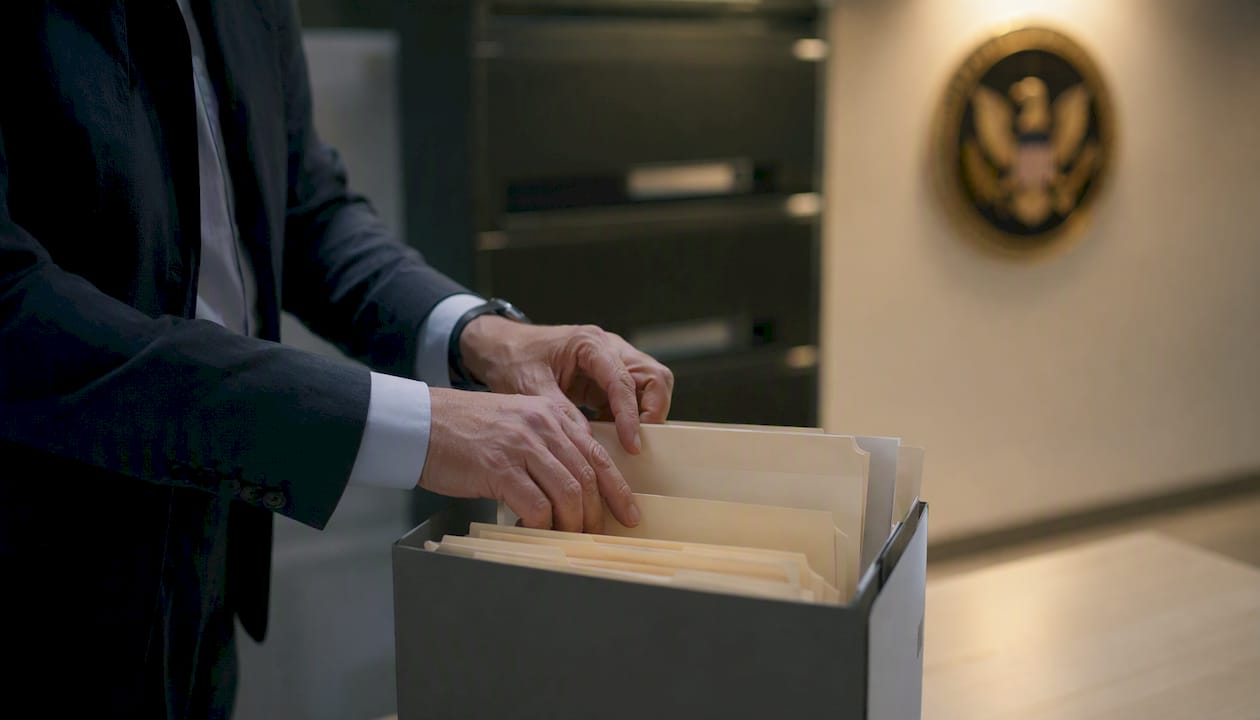 Investigator hands organizing secure case files
