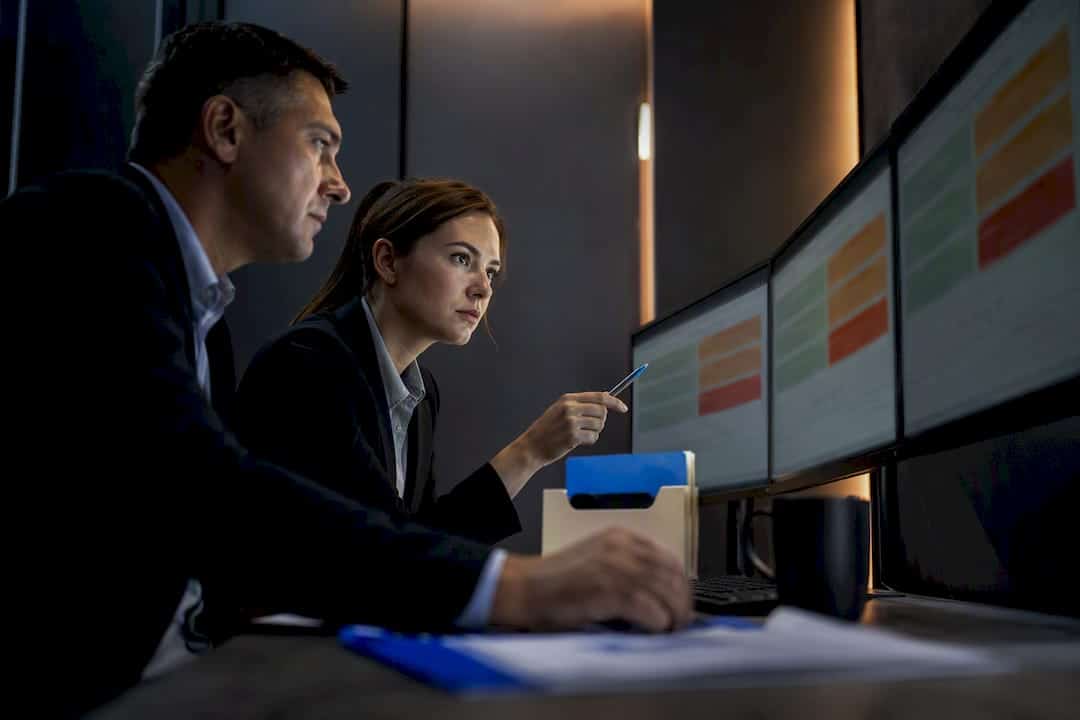 Investigators reviewing a hiring adjudication matrix